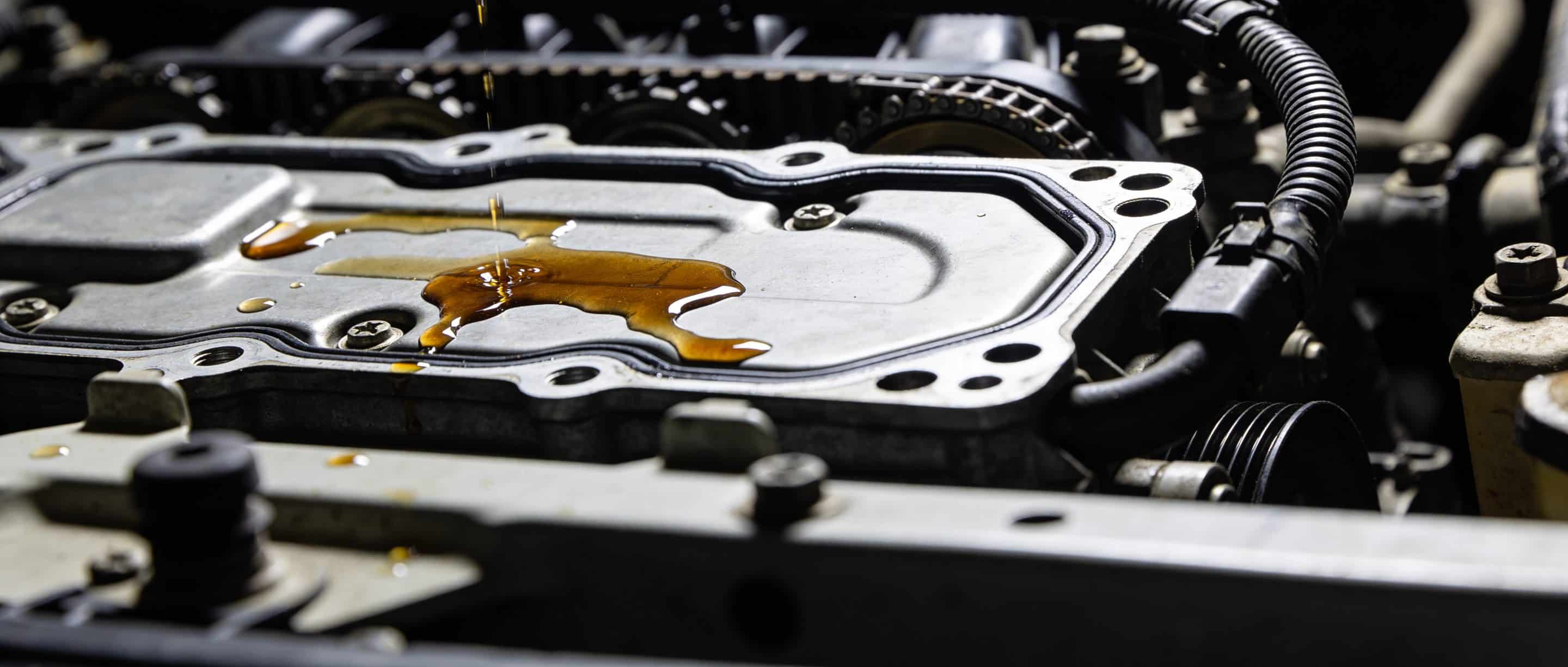 Engine bay inspection showing common leak points around gaskets and seals