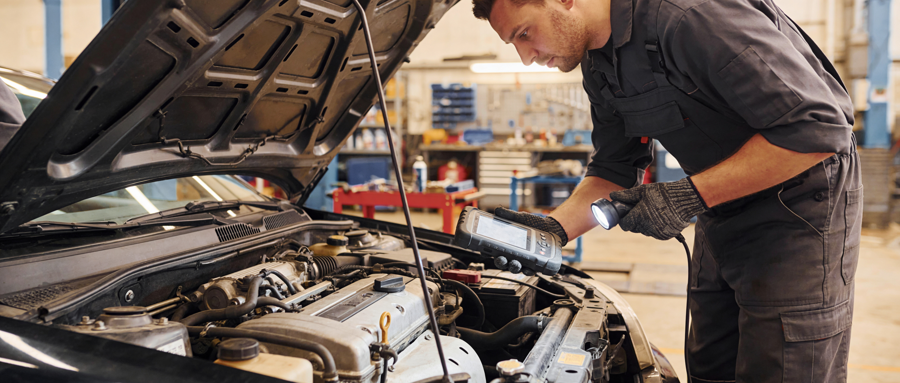 Professional mechanic conducting thorough pre-purchase inspection of used vehicle